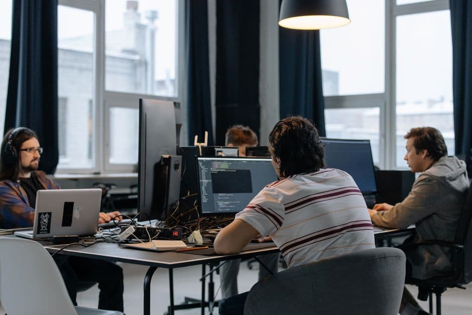 Equipa de programadores a desenvolver um agente de inteligência artificial à medida